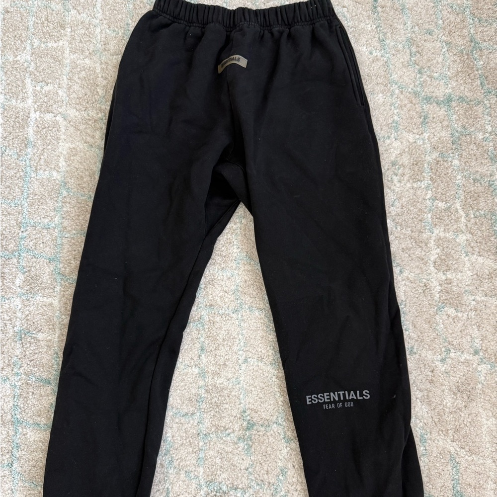 Black ESSENTIALS sweatpants.